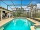 A screened-in pool features clear water and a large deck area perfect for outdoor entertaining at 1680 Blackwelder Rd, De Leon Springs, FL 32130