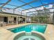 Inviting screened pool and spa with outdoor dining area at 1680 Blackwelder Rd, De Leon Springs, FL 32130