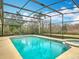 Inviting screened pool and spa with tranquil views of the backyard at 1680 Blackwelder Rd, De Leon Springs, FL 32130