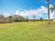 Large grassy backyard offers ample space for outdoor activities and recreation at 1680 Blackwelder Rd, De Leon Springs, FL 32130