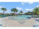 Relaxing community pool area with sun loungers and palm trees on a sunny day at 1742 Three Bars Rd, Kissimmee, FL 34744