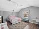 A tranquil bedroom featuring neutral walls, wood floors, ceiling fan, and a cozy window seat at 1943 Kodsi Ct, Winter Garden, FL 34787