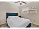 Cozy bedroom with a comfortable bed, neutral walls, and a window at 203 North E Blvd, Davenport, FL 33837