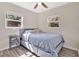 Comfortable bedroom featuring stylish decor, ample natural light from two windows at 203 North E Blvd, Davenport, FL 33837