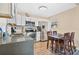 Well-lit kitchen featuring modern appliances, white cabinets, countertops and an adjacent dining space at 203 North E Blvd, Davenport, FL 33837