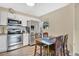 Bright kitchen showcasing stainless steel appliances, white cabinetry, and a cozy dining table at 203 North E Blvd, Davenport, FL 33837