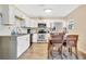 Modern kitchen featuring stainless steel appliances, white cabinets, and a dining area at 203 North E Blvd, Davenport, FL 33837