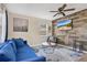 Inviting living room featuring a comfortable sofa, stylish decor, and ample natural light through the windows at 203 North E Blvd, Davenport, FL 33837