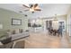 Open-concept living area with hardwood floors connecting kitchen and dining areas at 2107 Stone Cross Cir, Orlando, FL 32828