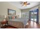 Well-lit main bedroom with ensuite, a ceiling fan and sliding glass door access to the pool at 2107 Stone Cross Cir, Orlando, FL 32828