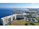 Aerial view of waterfront condo complex overlooking a marina and bay, near parking and lush greenery at 225 W Seminole Blvd # 314, Sanford, FL 32771