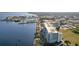 Aerial view of a condominium with waterfront views and a nearby marina, set against a cityscape backdrop at 225 W Seminole Blvd # 314, Sanford, FL 32771
