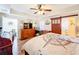 Bedroom with hardwood floors, ceiling fan, nautical decor, dresser, and a sliding barn door at 225 W Seminole Blvd # 314, Sanford, FL 32771