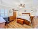 Bright bedroom featuring hardwood floors, a ceiling fan, and nautical-themed decor at 225 W Seminole Blvd # 314, Sanford, FL 32771