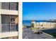 View of a condo balcony overlooking a waterfront with a building featuring arched entrances at 225 W Seminole Blvd # 314, Sanford, FL 32771