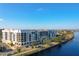 Scenic view of waterfront condo building with balconies overlooking the water and lush landscaping at 225 W Seminole Blvd # 314, Sanford, FL 32771