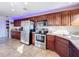 A kitchen featuring cherry cabinets, stainless steel appliances, and granite countertops at 225 W Seminole Blvd # 314, Sanford, FL 32771