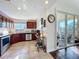 Bright kitchen features cherry cabinets, stainless steel appliances, and a sliding glass door to the balcony at 225 W Seminole Blvd # 314, Sanford, FL 32771