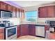 Cherry cabinets and stainless steel appliances are featured in this well-lit kitchen at 225 W Seminole Blvd # 314, Sanford, FL 32771