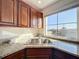 Close up of the kitchen sink and a granite countertop next to a window and wood cabinets at 225 W Seminole Blvd # 314, Sanford, FL 32771