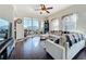 Comfortable living room with dark hardwood floors, a balcony, and a sectional couch at 225 W Seminole Blvd # 314, Sanford, FL 32771