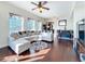 Living room area with white sectional, wood floors and access to bar and kitchen at 225 W Seminole Blvd # 314, Sanford, FL 32771