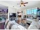 Open-concept living room with a view of the kitchen and a door to the balcony at 225 W Seminole Blvd # 314, Sanford, FL 32771