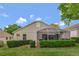 Exterior view of the home's backyard with a screened patio and well-maintained landscaping at 2308 Edmonton Ct, Clermont, FL 34711