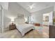 Serene bedroom with neutral tones, a large window, and ensuite bath provides a relaxing retreat at 2308 Edmonton Ct, Clermont, FL 34711