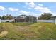 Wide view of backyard with screened in pool area and white vinyl fence at 2655 Sheila Dr, Apopka, FL 32712
