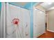 Bathroom featuring shower with decorative floral curtain, and a double door closet at 2655 Sheila Dr, Apopka, FL 32712