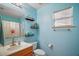 Bright bathroom with a single sink vanity, open shelving, and window at 2655 Sheila Dr, Apopka, FL 32712