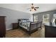 Comfortable bedroom featuring a wood frame bed, ceiling fan, wood floors, and bright windows at 2655 Sheila Dr, Apopka, FL 32712