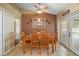 Cozy dining room with wood table, chairs, ceiling fan and door leading to an outdoor pool area at 2655 Sheila Dr, Apopka, FL 32712