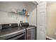 Well-equipped laundry room with front loading washer and dryer and wire shelving at 2655 Sheila Dr, Apopka, FL 32712