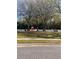 Community playground with swings, slides, playhouse, and benches under shady trees at 2655 Sheila Dr, Apopka, FL 32712