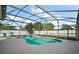 Enclosed pool area with lush tropical landscaping and lounge seating at 2655 Sheila Dr, Apopka, FL 32712