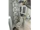Small bathroom with a shower, toilet, vanity, and a cabinet for storage at 333 Lake Howard Nw Dr # 201C, Winter Haven, FL 33880