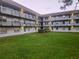 Three-story condo building with balconies overlooking a well-maintained courtyard at 333 Lake Howard Nw Dr # 201C, Winter Haven, FL 33880