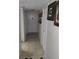 Long hallway with tiled floor leading to the unit's front door at 333 Lake Howard Nw Dr # 201C, Winter Haven, FL 33880