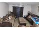 Spacious living room with couches, an ottoman, and large window providing natural light at 333 Lake Howard Nw Dr # 201C, Winter Haven, FL 33880