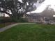Inviting outdoor area featuring lush landscaping, mature trees, a covered picnic pavilion, and a community pool at 333 Lake Howard Nw Dr # 201C, Winter Haven, FL 33880