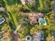 A bird's eye view showcasing the beautiful landscaping, expansive lawn, and private pool area at 3412 Lilas Ct, Windermere, FL 34786