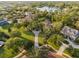 Aerial view showcasing the expansive property, lush landscaping, and serene lake nearby at 3412 Lilas Ct, Windermere, FL 34786