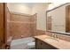 Bathroom featuring tile, a vanity with granite counter, a mirror, and a shower-tub combo at 3412 Lilas Ct, Windermere, FL 34786