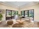 Bright living room features recessed ceilings, travertine floors, and sliding glass doors opening to the pool at 3412 Lilas Ct, Windermere, FL 34786