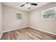 Bedroom with wood flooring, a ceiling fan, and two windows providing natural light at 353 E Orange St, Altamonte Springs, FL 32701