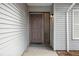 Inviting front entrance with a solid door, sleek hardware and complementary siding details at 353 E Orange St, Altamonte Springs, FL 32701