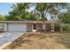 Charming single-story brick home with attached garage and mature trees in a well-maintained yard at 353 E Orange St, Altamonte Springs, FL 32701