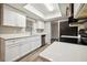 Modern kitchen features white cabinets, stainless steel appliances, and bright countertops at 353 E Orange St, Altamonte Springs, FL 32701